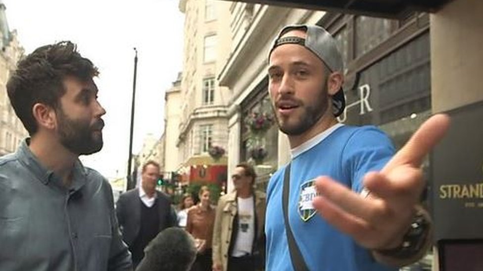 Screen grab from the documentary showing the reporter asking questions of Richard Hood