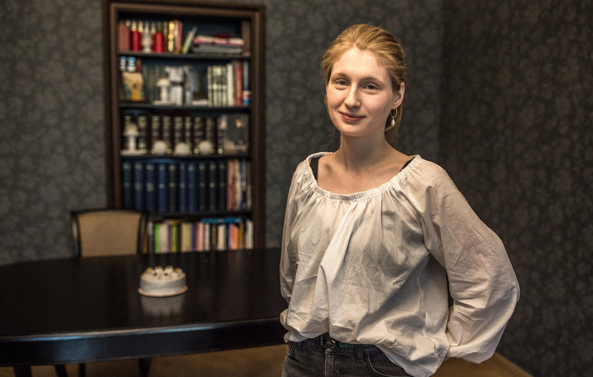 Sonia, the vegan baker who runs Run Rabbit Run, photographed in front of a bookcase