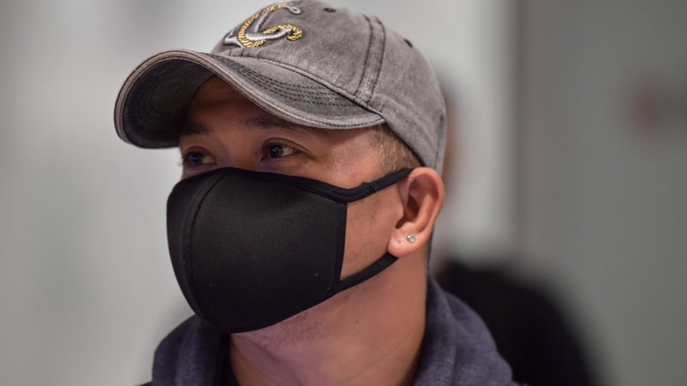 A man wears a mask in Guarulhos International Airport, in Guarulhos, Sao Paulo, Brazil