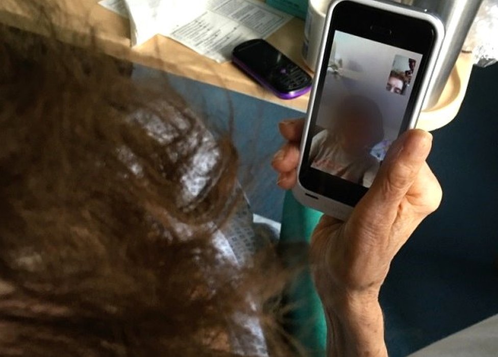 Kathleen talking to her graddaughter on a phone