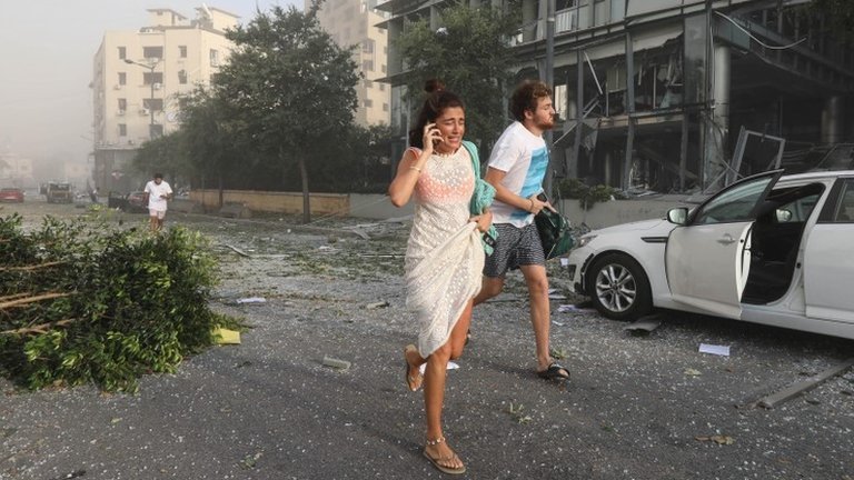 People run for cover following an explosion in Beirut"s port area, Lebanon August 4, 2020