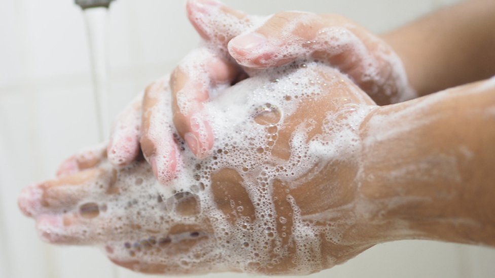 A person washing their hands.