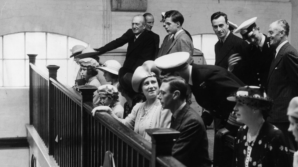 Princess Elizabeth (third from left), with King George VI, Lord Louis Mountbatten and Queen Elizabeth, the Queen Mother during a visit to the chapel at the Royal Naval College, Dartmouth on 23rd July 1939. Also present is naval cadet Prince Philip of Greece and Denmark (later Prince Philip, Duke of Edinburgh, standing, second from right)