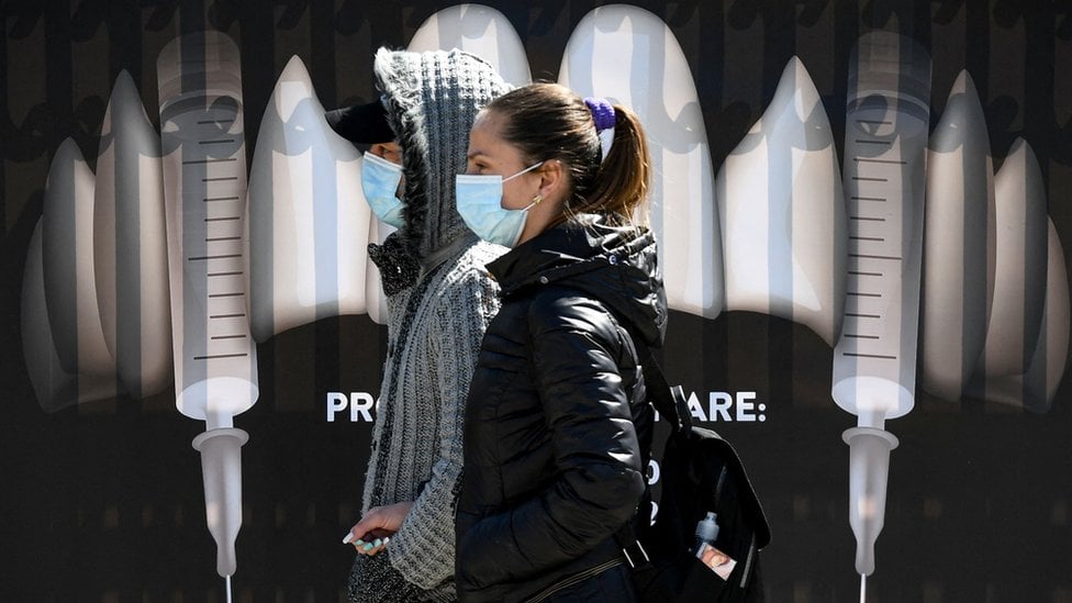 People walk past vampire-themed branding