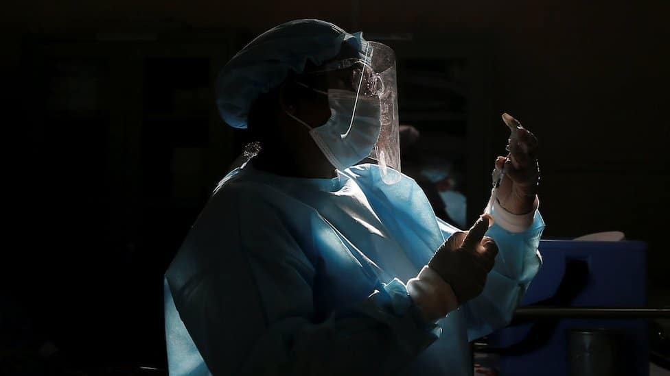 Healthcare worker draws a dose of China's Sinopharm COVID-19 vaccine as people wait to receive their shots in Colombo, Sri Lanka May 8, 2021.