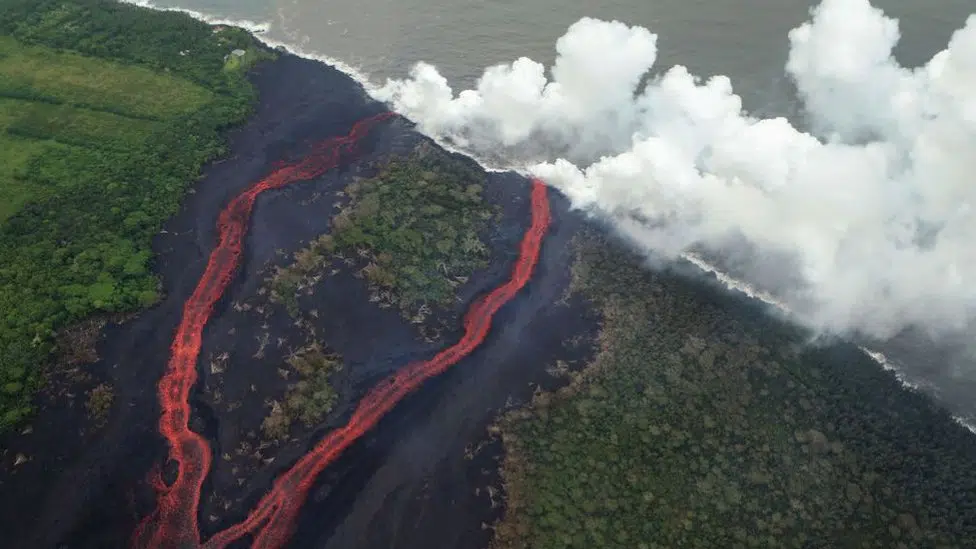 Steam plumes rise as lava enters the Pacific Ocean, after flowing to the water from a Kilauea volcano fissure, on Hawaii's Big Island on May 21, 2018 near Pahoa, Hawaii.