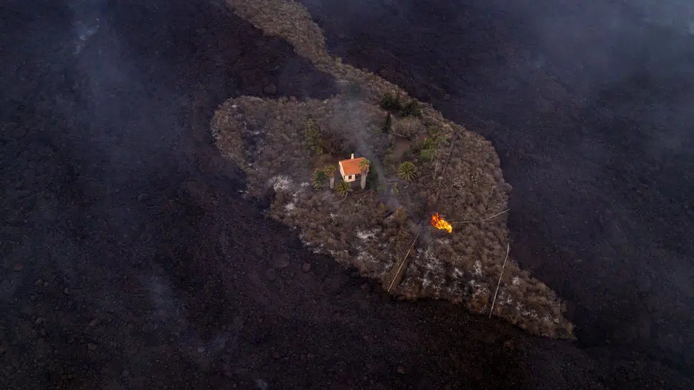 A house sits surrounded by lava in La Palma