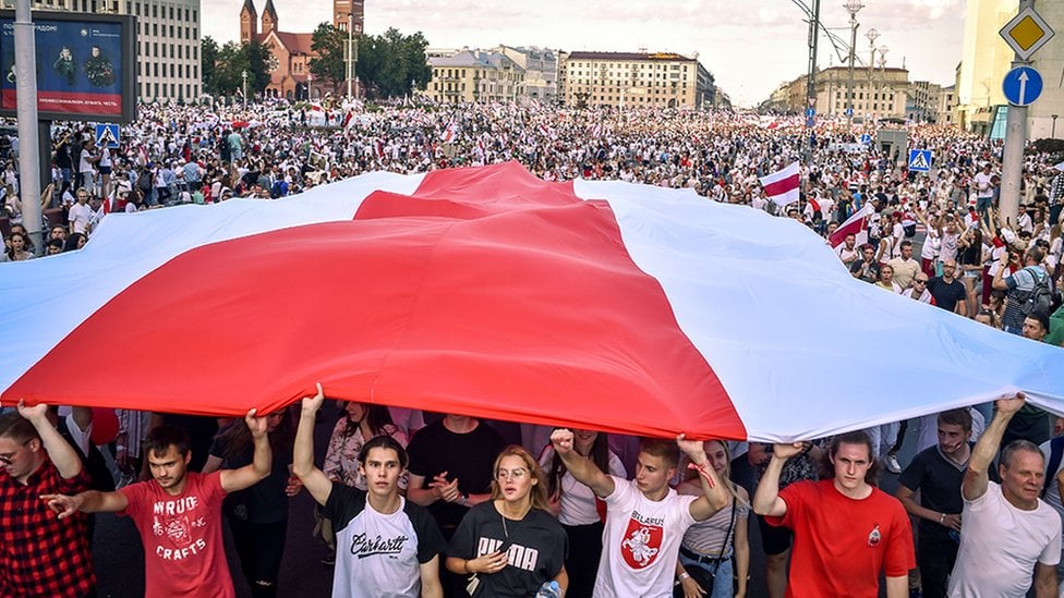 Opposition supporters hold a flag in opposition to the government