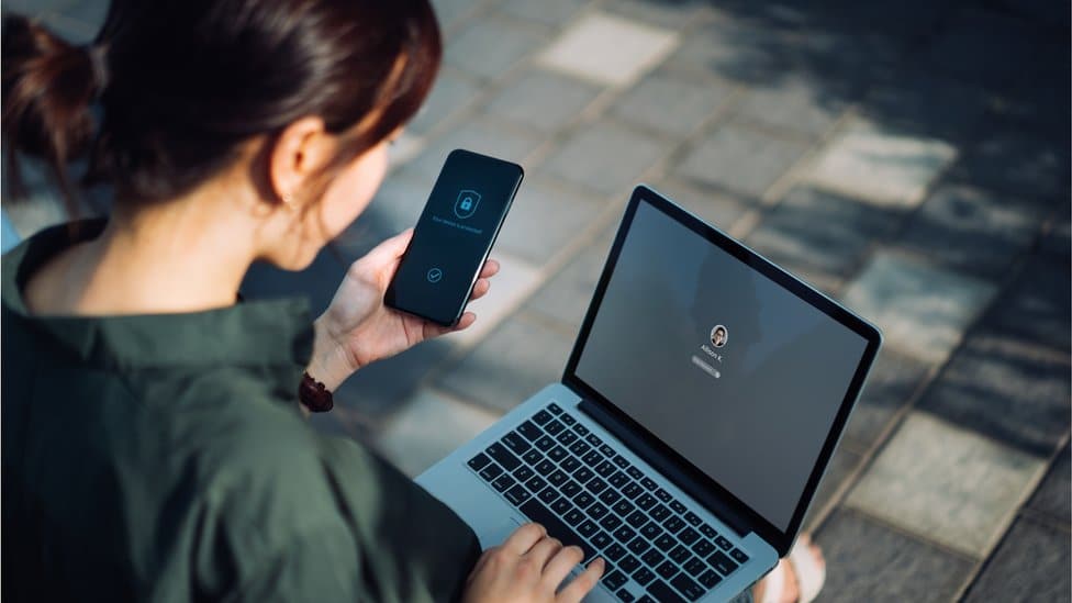 Woman with laptop and phone