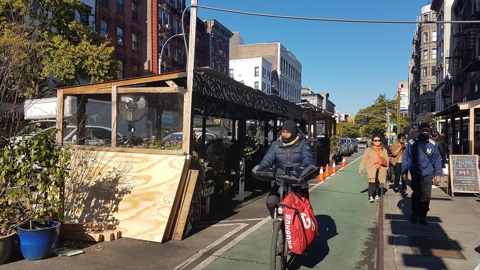 Cyclist in front of street shed