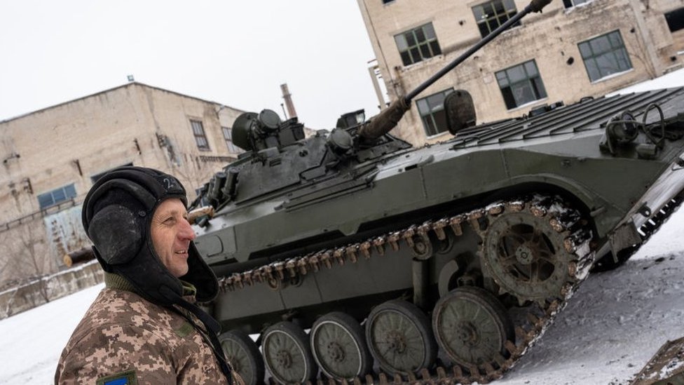 A Ukrainian soldier and a tank, January 2022