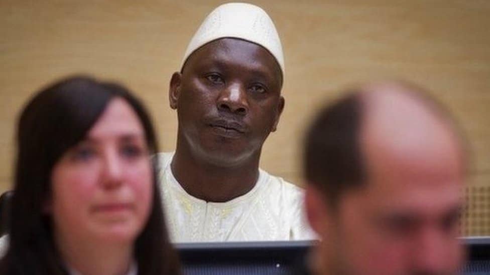 A close-up shot of a man in court looking ahead