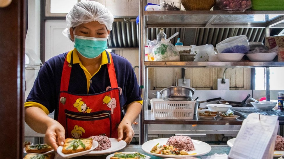 A chef in PrachinBuri preparing a dish with cannabis leaves