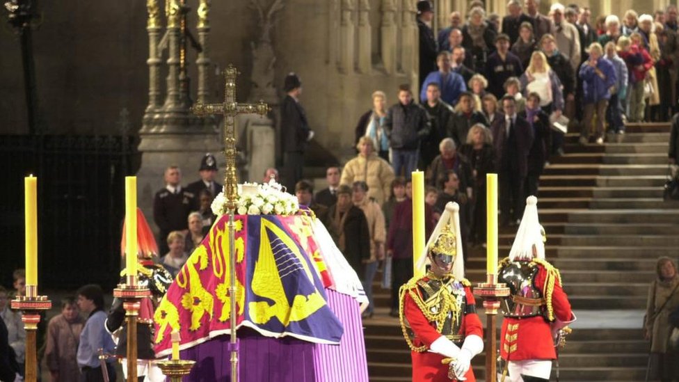 People queue to file past the Queen Mother's coffin during her lying in state in 2002