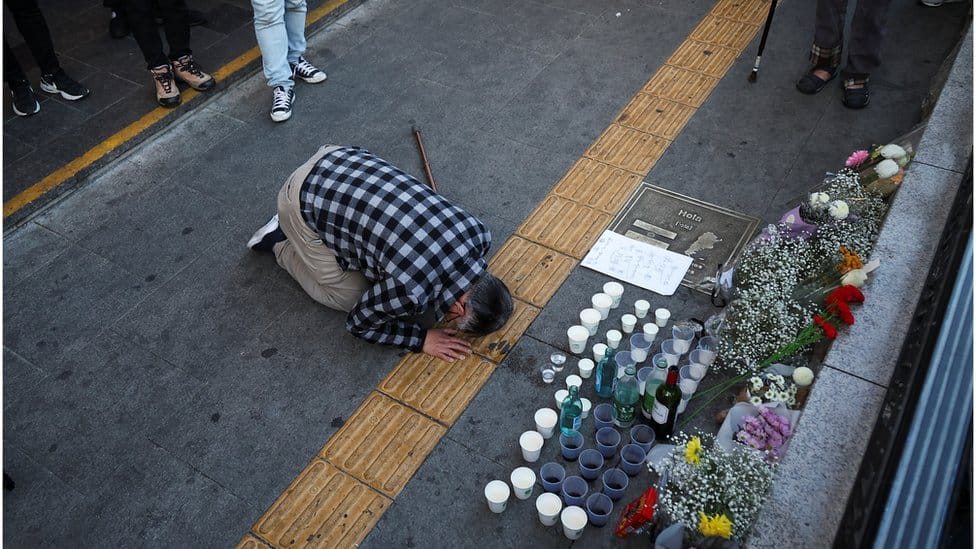 A person pays tribute near the scene of the stampede during Halloween festivities, in Seoul