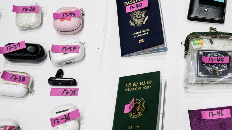 Close up of victims passports, earphones and belongings.