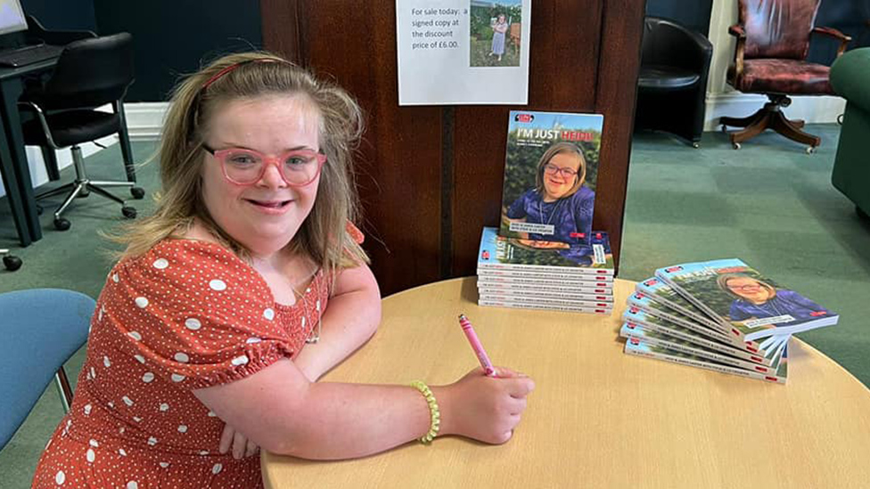 Heidi signing copies of her book