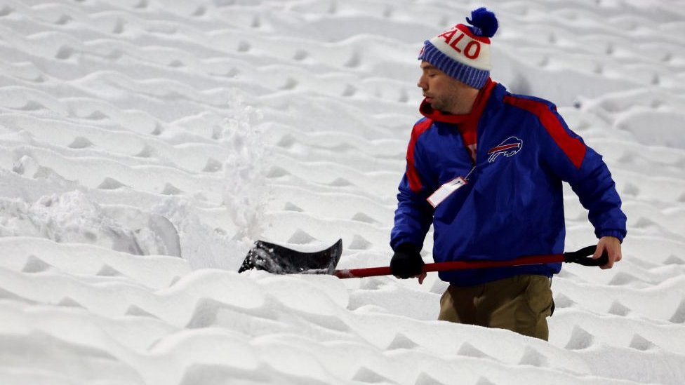 Stadium seats being cleared on snow on 17 December in New York