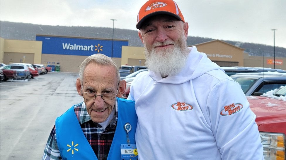 Two men smile for a portrait.