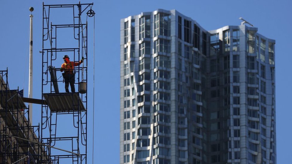 A worker stands on scaffolding in New York City, U.S., March 29, 2023.