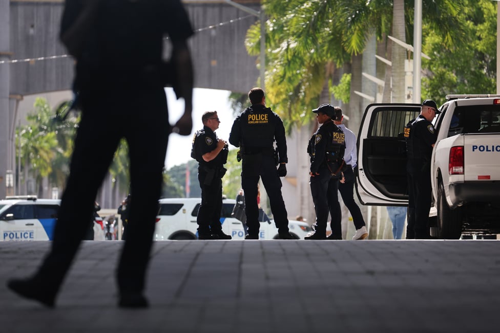 Law enforcement officials stand guard at a transit stop outside of the Wilkie D. Ferguson Jr. federal courthouse on June 13, 2023 in Miami, Florida