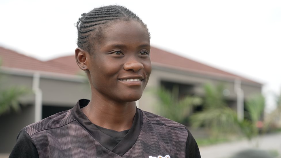 Evarine Katongo standing in a football jersey