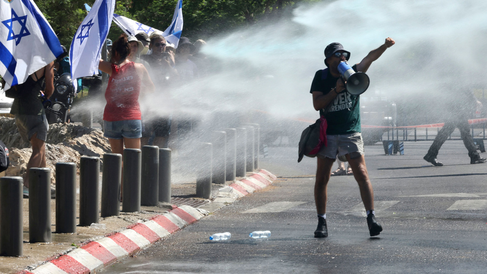 Protesters sprayed with water cannon outside Israel's parliament