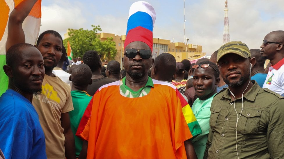 A supporter of the coup wears a hat in the colours of the Russian flag during a rally in the capital on Thursday