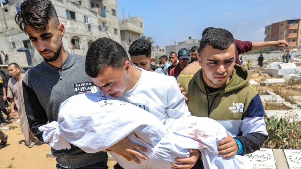 People mourn as they bury the dead bodies of victims of an Israeli strike on 11 April, 2024 in Rafah, Gaza.