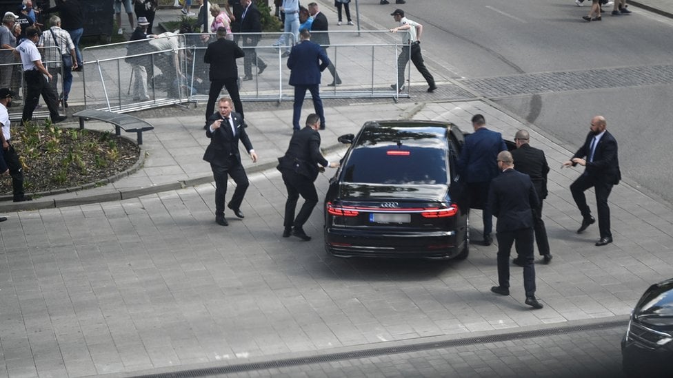 Security officers move Slovak PM Robert Fico in a car after a shooting incident, after a Slovak government meeting in Handlova,