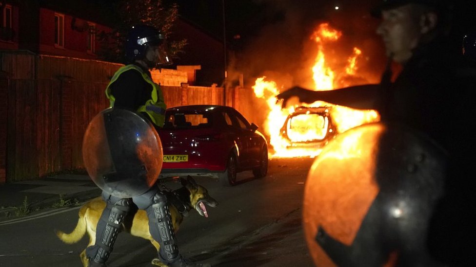 A police car burns as officers are deployed on the streets of Hartlepool following a violent protest. Videos on social media show a crowd of people in a street, with one showing a youth throwing objects at a line of police in riot gear holding shields. It comes after similar disorder in Merseyside and Whitehall, London after the mass stabbing in Southport that claimed the lives of three girls and left eight more children and two adults injured. Picture date: Wednesday July 31, 2024. PA Photo. See PA story POLICE Southport. Photo credit should read: Owen Humphreys/PA Wire