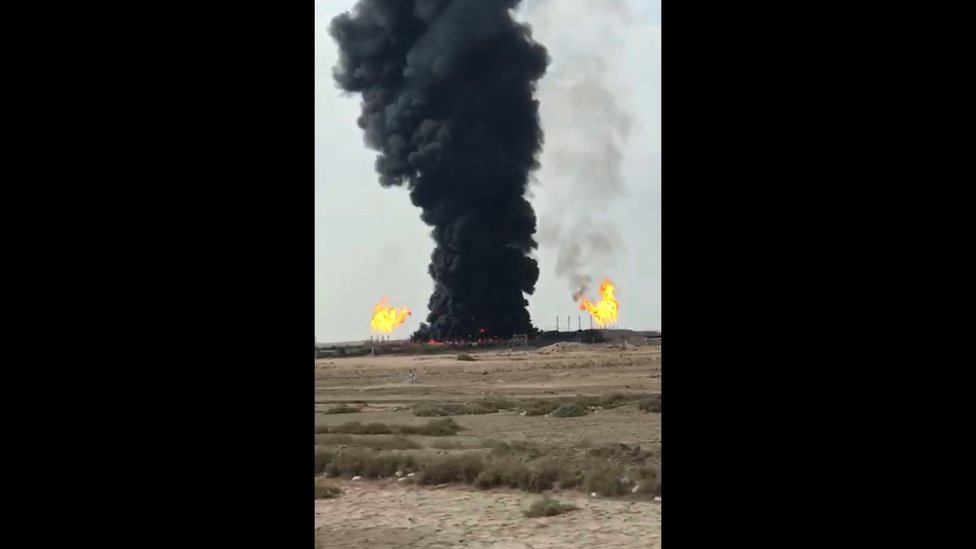 thick plumes of black smoke from Rumaila oil field