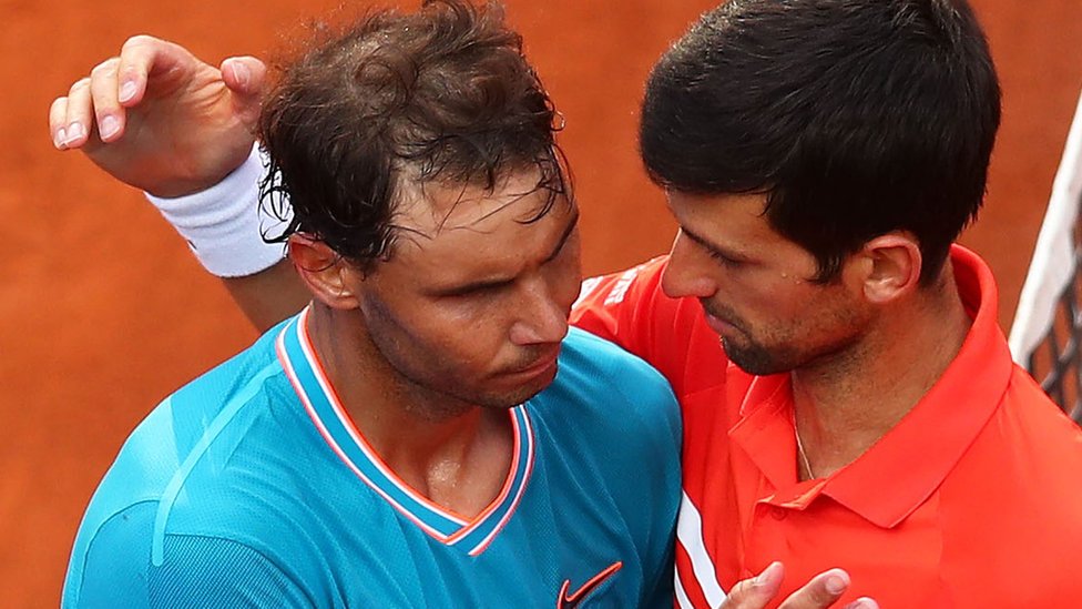 Rafael Nadal and Novak Djokovic hug after a match at the 2019 Italian Open