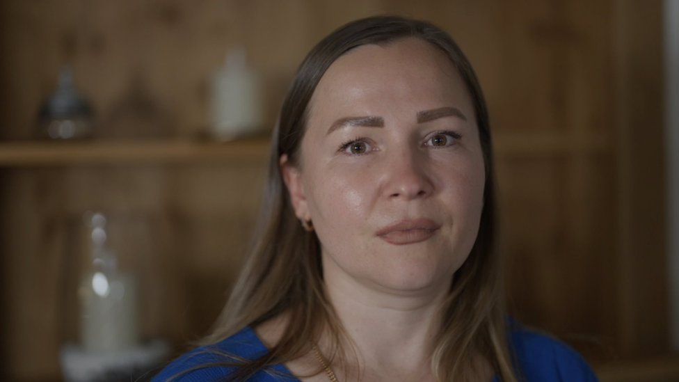 Marina Perederii with long straight brown hair, wearing a blue top