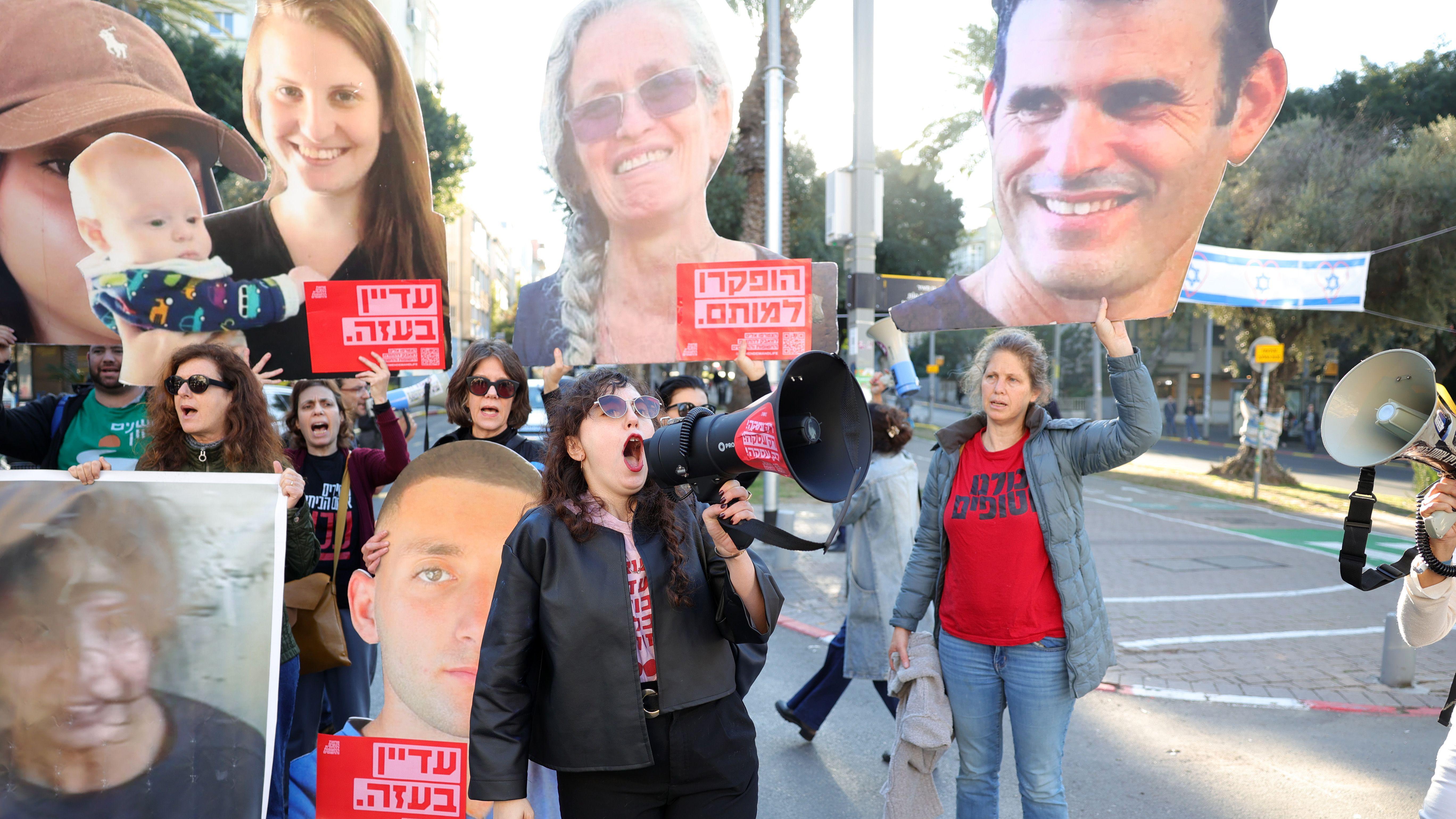 Families of hostages held by Hamas in Gaza and their supporters carry pictures of hostages outside the Likud Party headquarters on 8 January 2025, during a protest calling for a ceasefire and hostage releases 